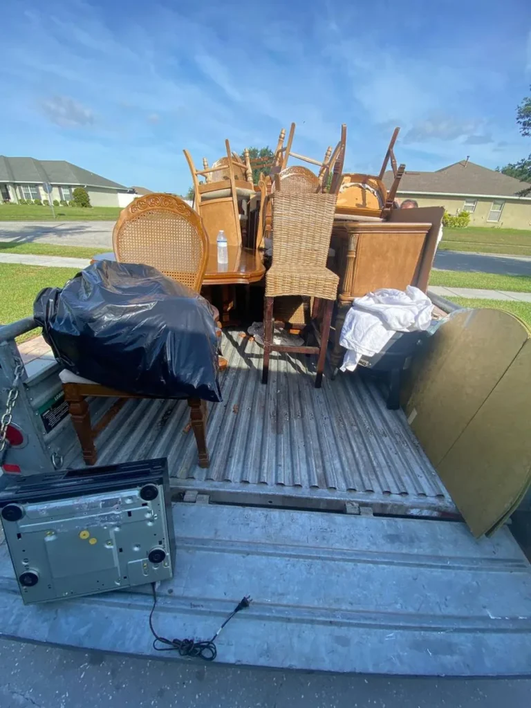 Loaded trailer with furniture and junk ready for hauling