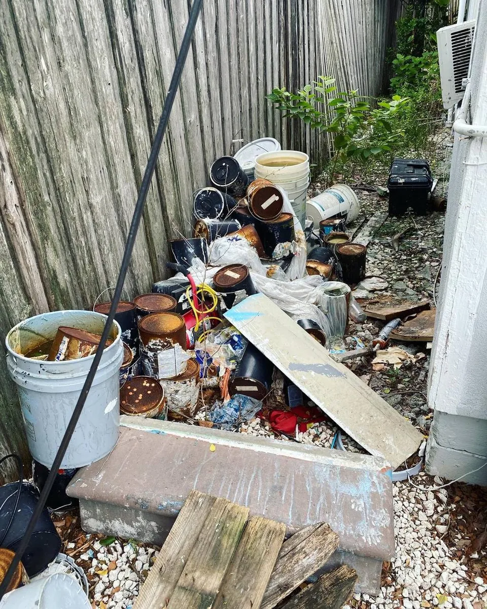 Side yard junk and debris before cleanup